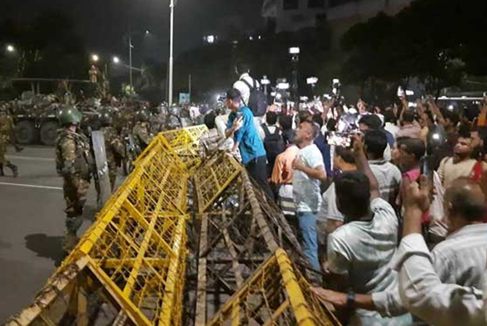 Law enforcers stop protesters from breaking thru barricade in front of Bangabhaban