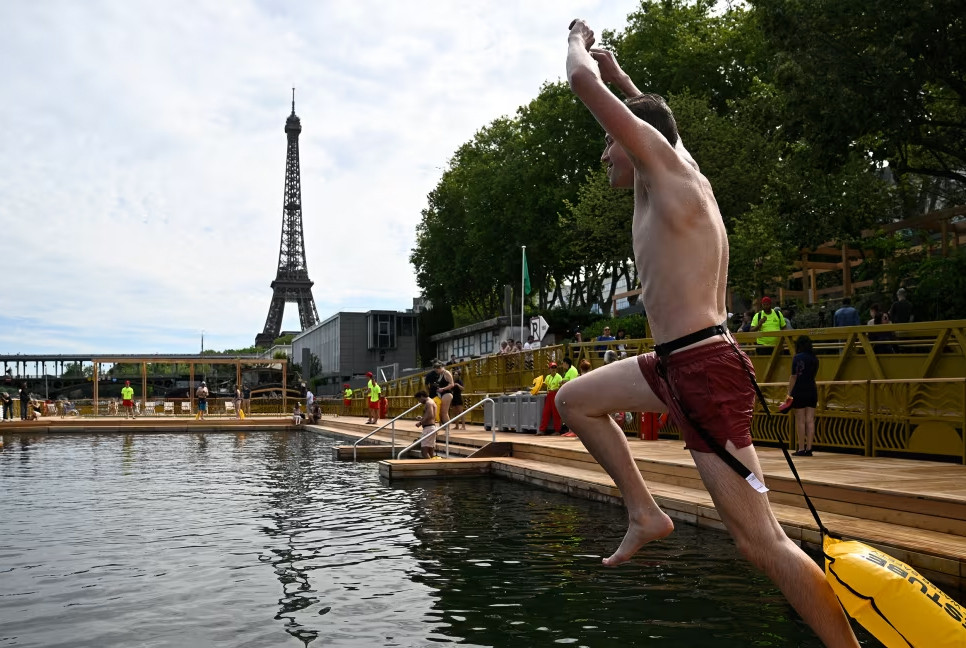 Joyful Parisians take a historic plunge into the Seine after 100 years