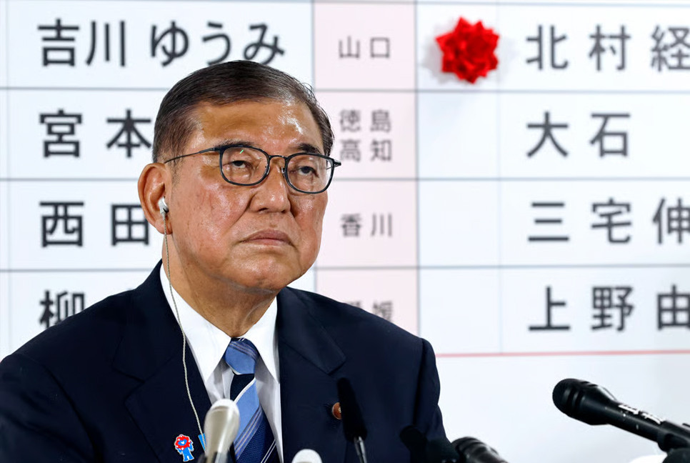 Japan's PM vows to stay on despite bruising election loss